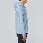 Light blue hoodie worn by a person on a plain background